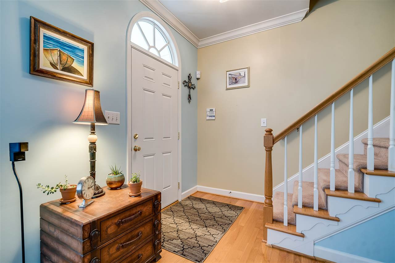 Alarm System on the wall behind front door. Stairs heading up. Entry