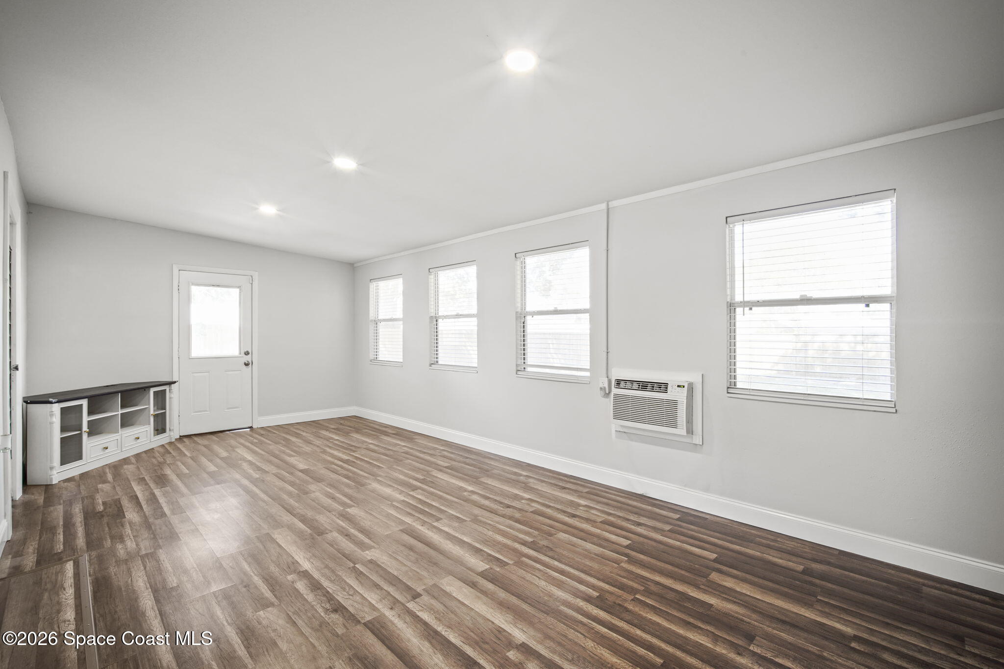 4665 Tuscarora Road Titusville, FL 32780 - Photo 15 of 34 a view of empty room with wooden floor and fan