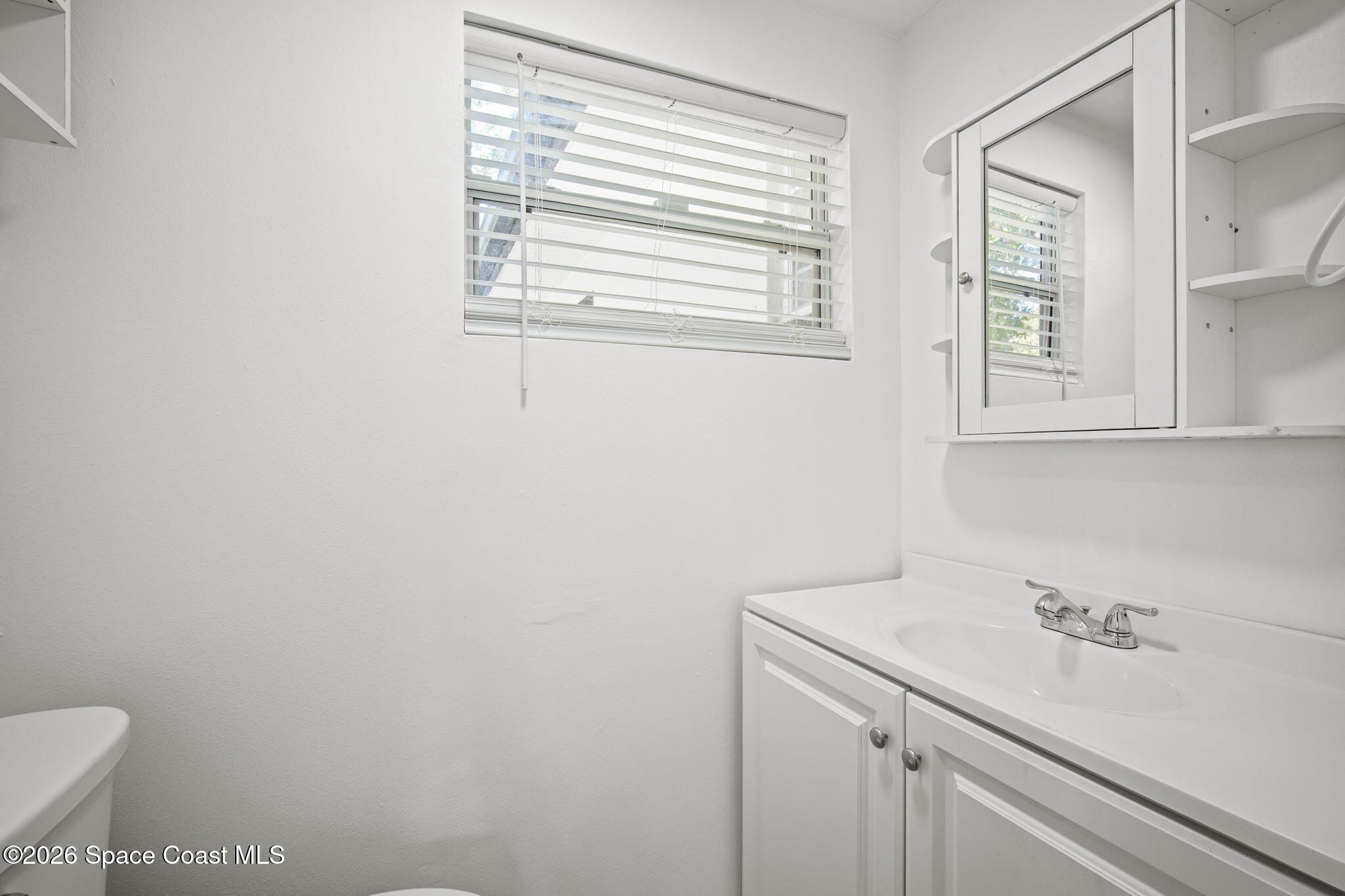 4665 Tuscarora Road Titusville, FL 32780 - Photo 17 of 34 a bathroom with a sink and a toilet