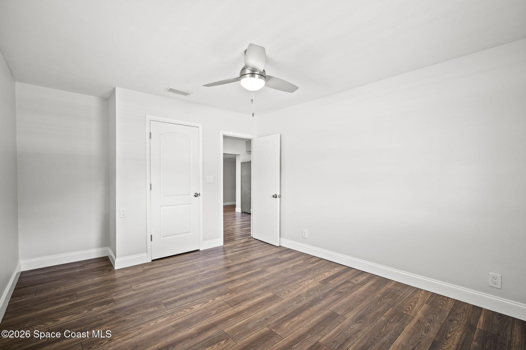 4665 Tuscarora Road Titusville, FL 32780 - Photo 20 of 34 wooden floor in an empty room