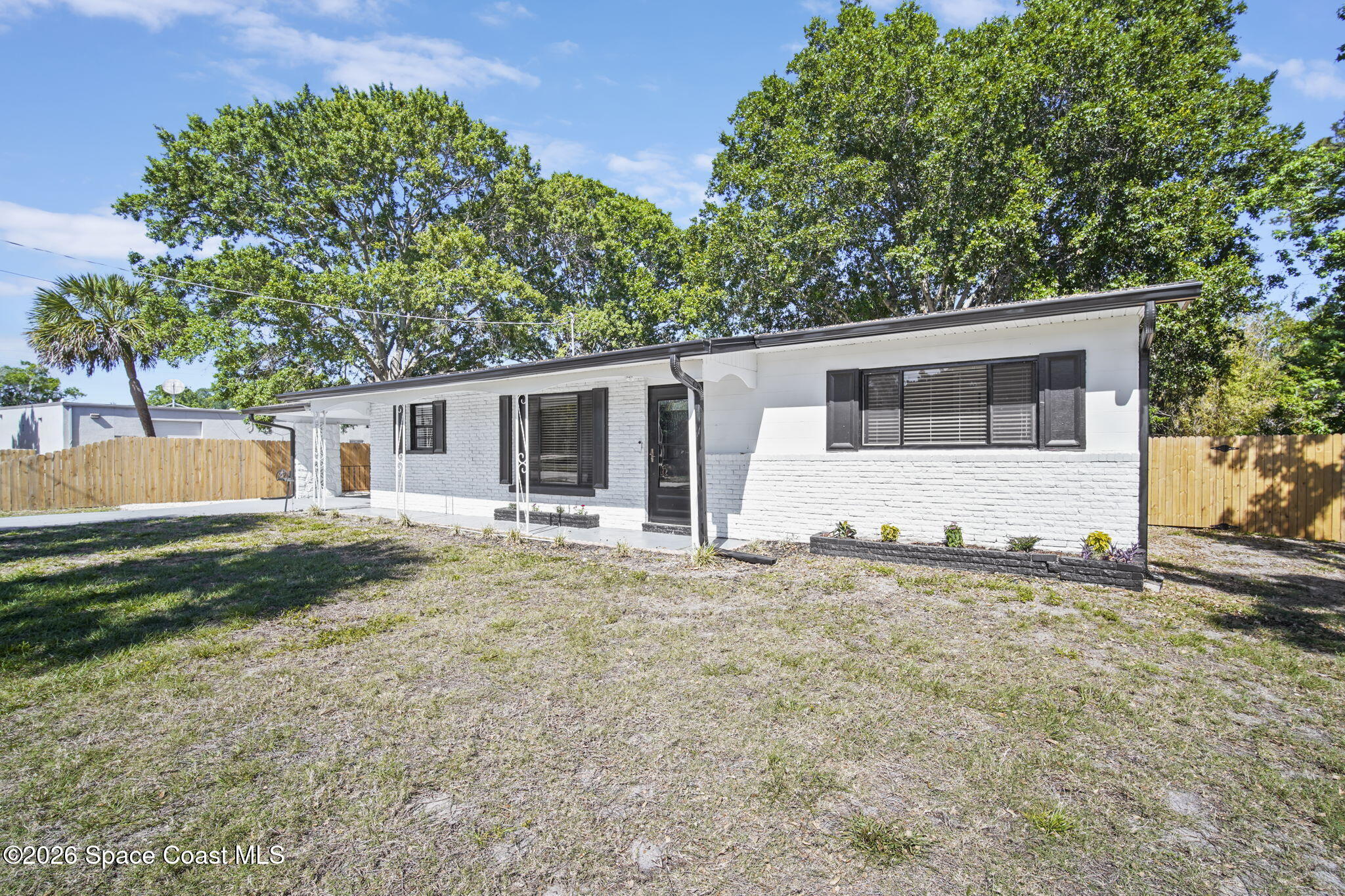 4665 Tuscarora Road Titusville, FL 32780 - Photo 2 of 34 front view of a house with a yard