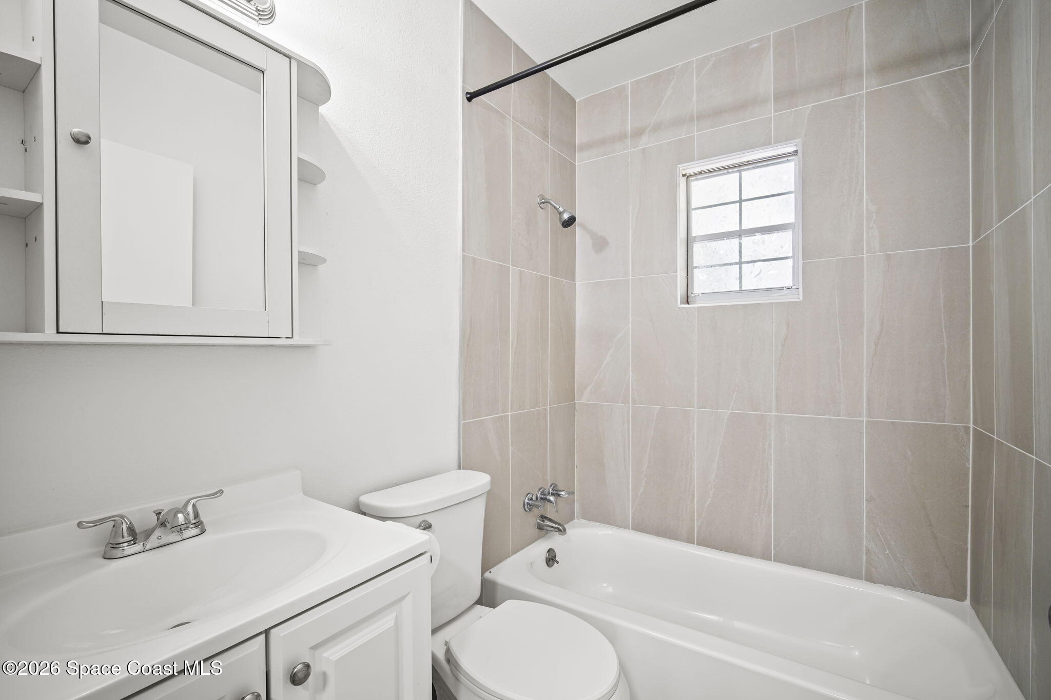 4665 Tuscarora Road Titusville, FL 32780 - Photo 21 of 34 a bathroom with a sink toilet and shower