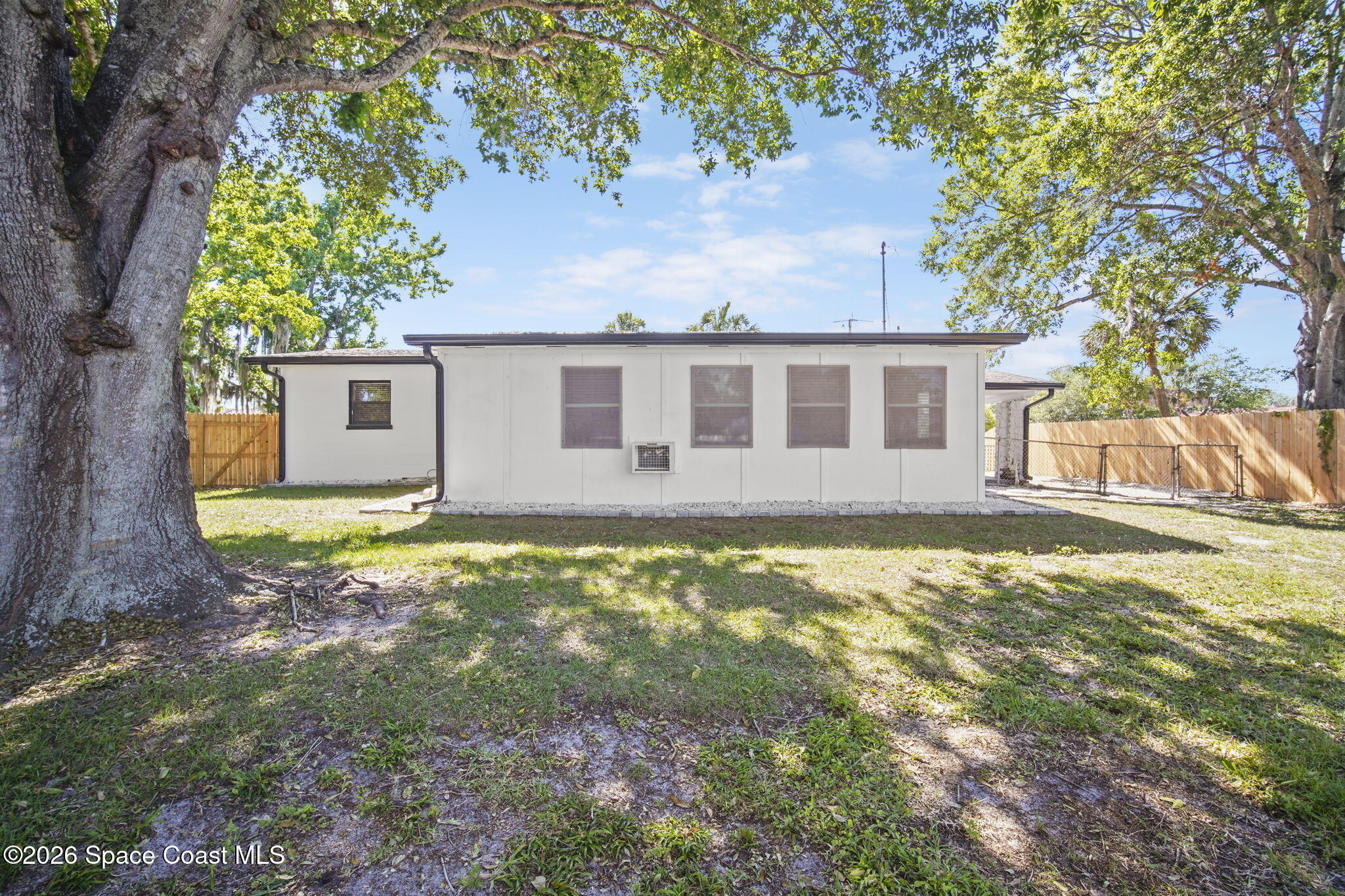 4665 Tuscarora Road Titusville, FL 32780 - Photo 28 of 34 a view of a house with a yard