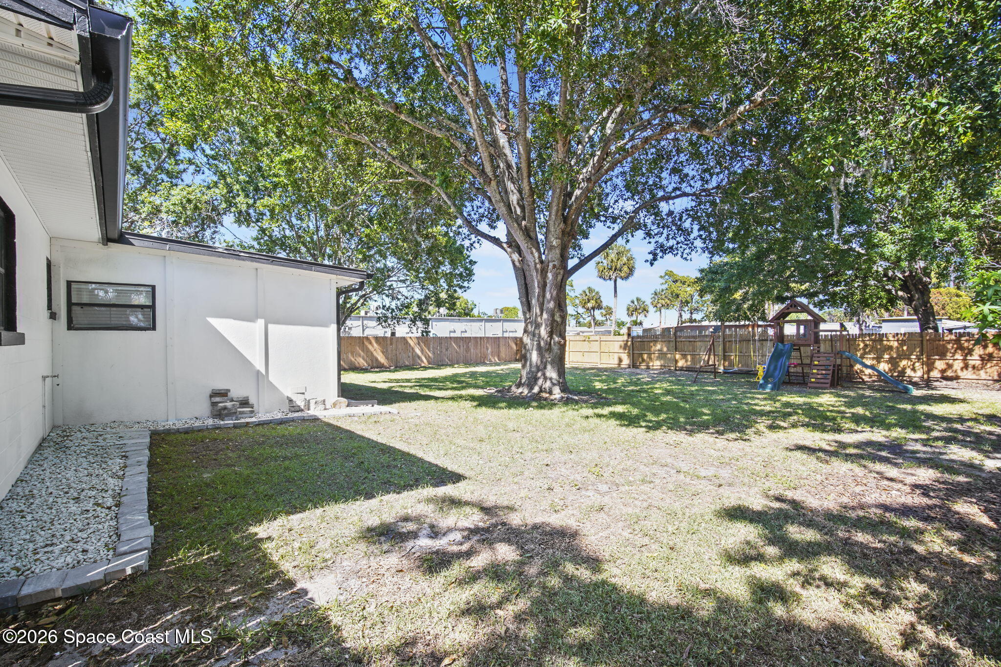 4665 Tuscarora Road Titusville, FL 32780 - Photo 30 of 34 a view of a yard with a tree