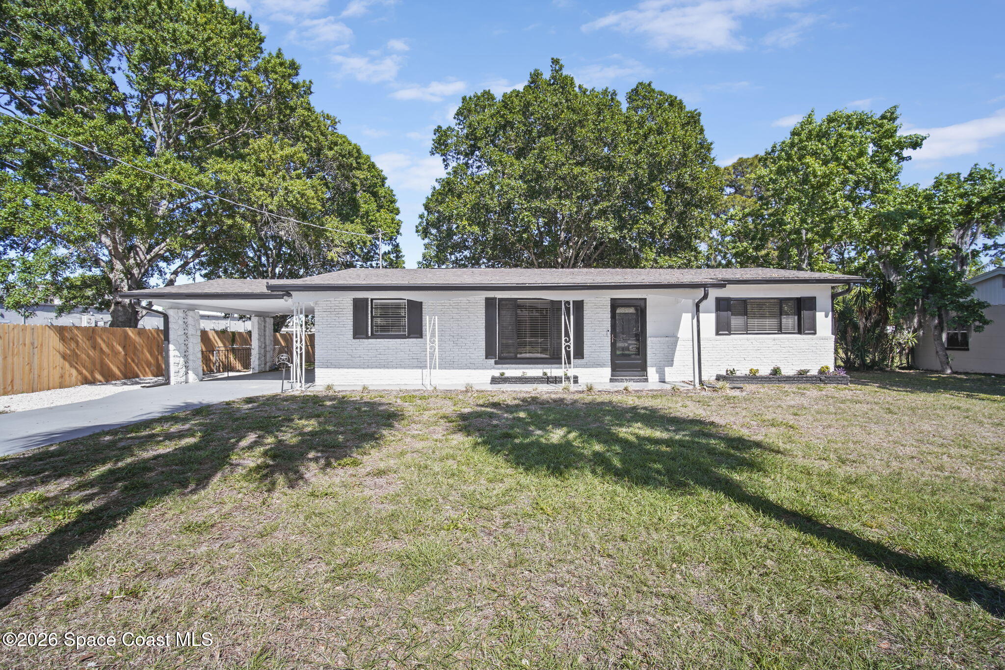 4665 Tuscarora Road Titusville, FL 32780 - Photo 3 of 34 front view of a house with a yard