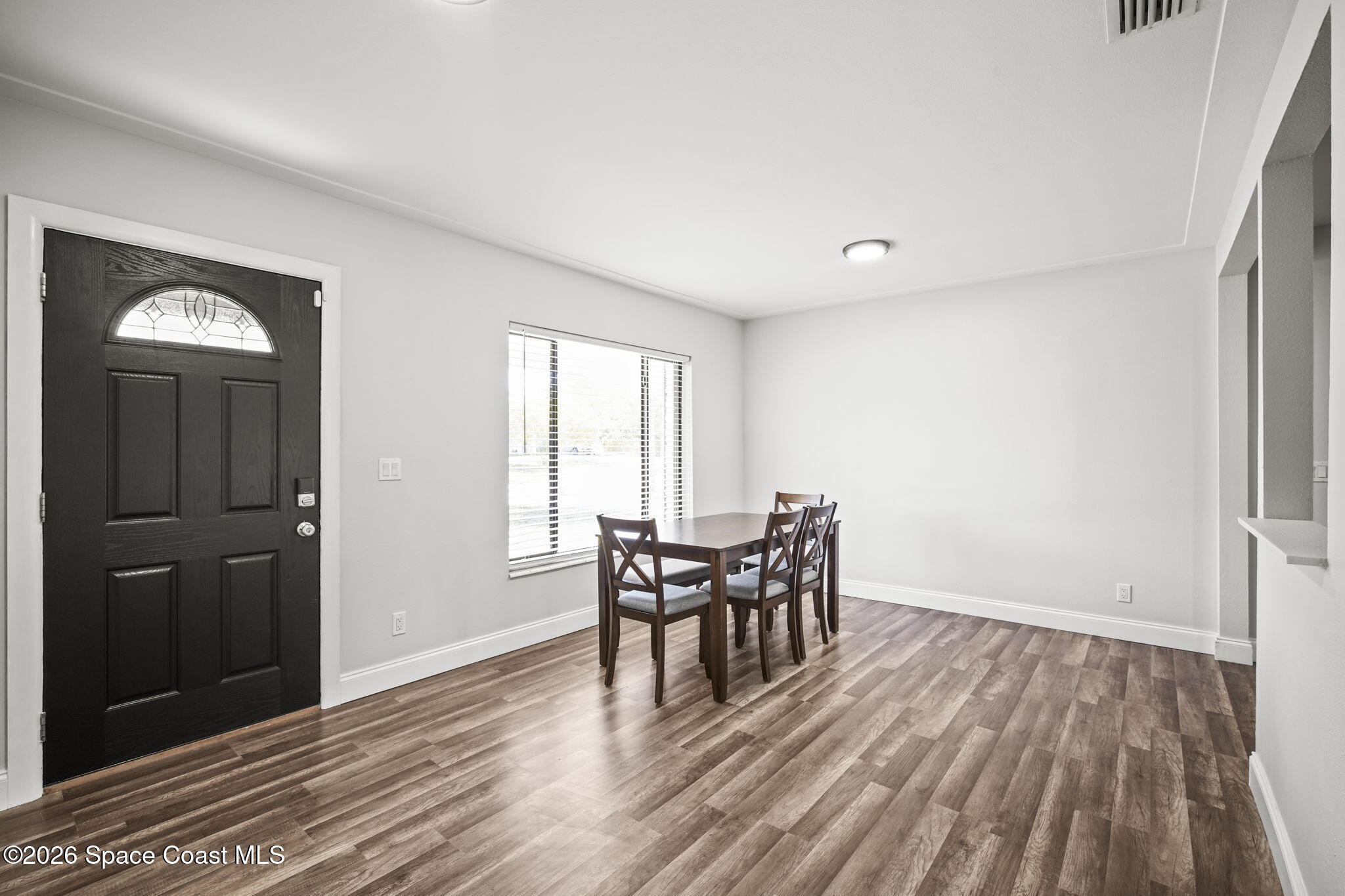4665 Tuscarora Road Titusville, FL 32780 - Photo 5 of 34 a view of a dining room with furniture and wooden floor