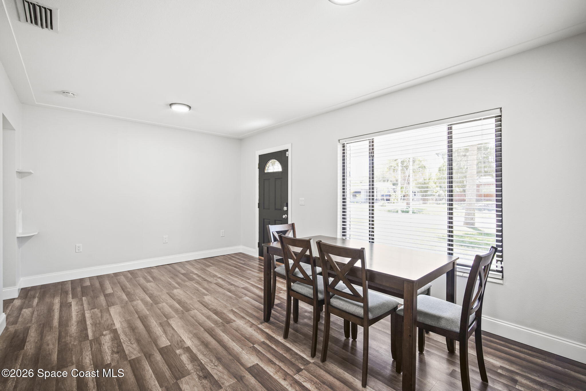 4665 Tuscarora Road Titusville, FL 32780 - Photo 6 of 34 a view of a dining room with furniture and wooden floor