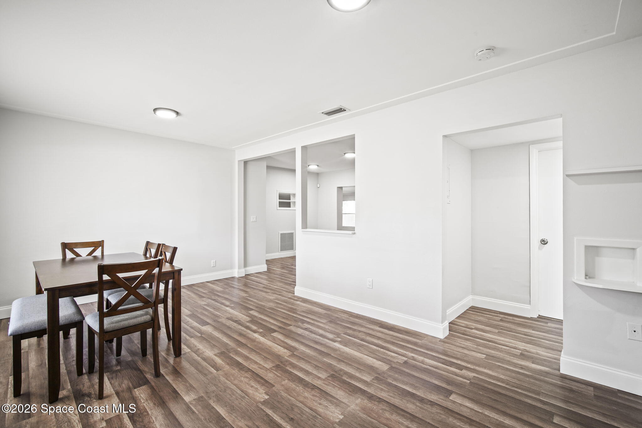 4665 Tuscarora Road Titusville, FL 32780 - Photo 7 of 34 a view of a livingroom with furniture and wooden floor