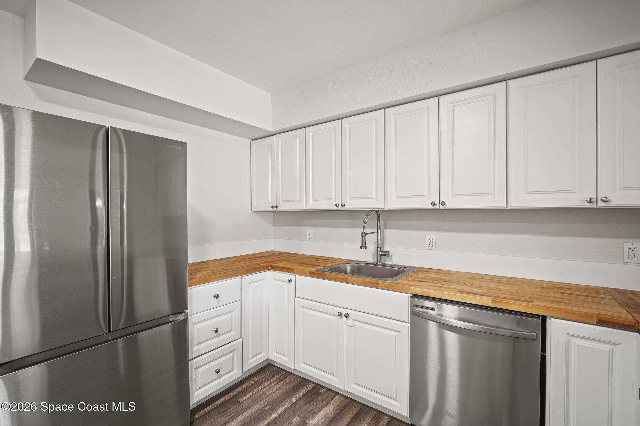 4665 Tuscarora Road Titusville, FL 32780 - Photo 10 of 34 a kitchen with appliances cabinets and a sink