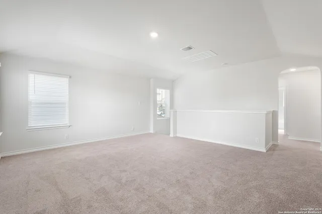 an empty room with windows and closet