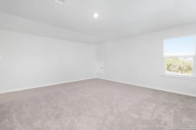 an empty room with a empty space and window