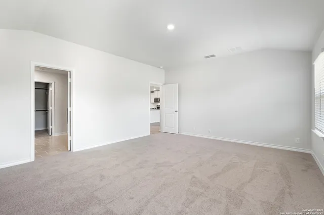 a spacious bathroom with a double vanity sink a mirror and a bathtub