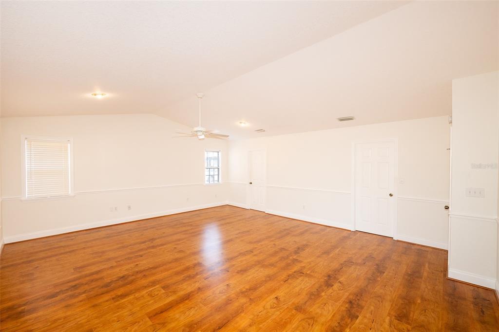 8077 Lake Hatchineha Road Haines City, FL 33844 - Photo 14 of 45 a view of empty room with wooden floor