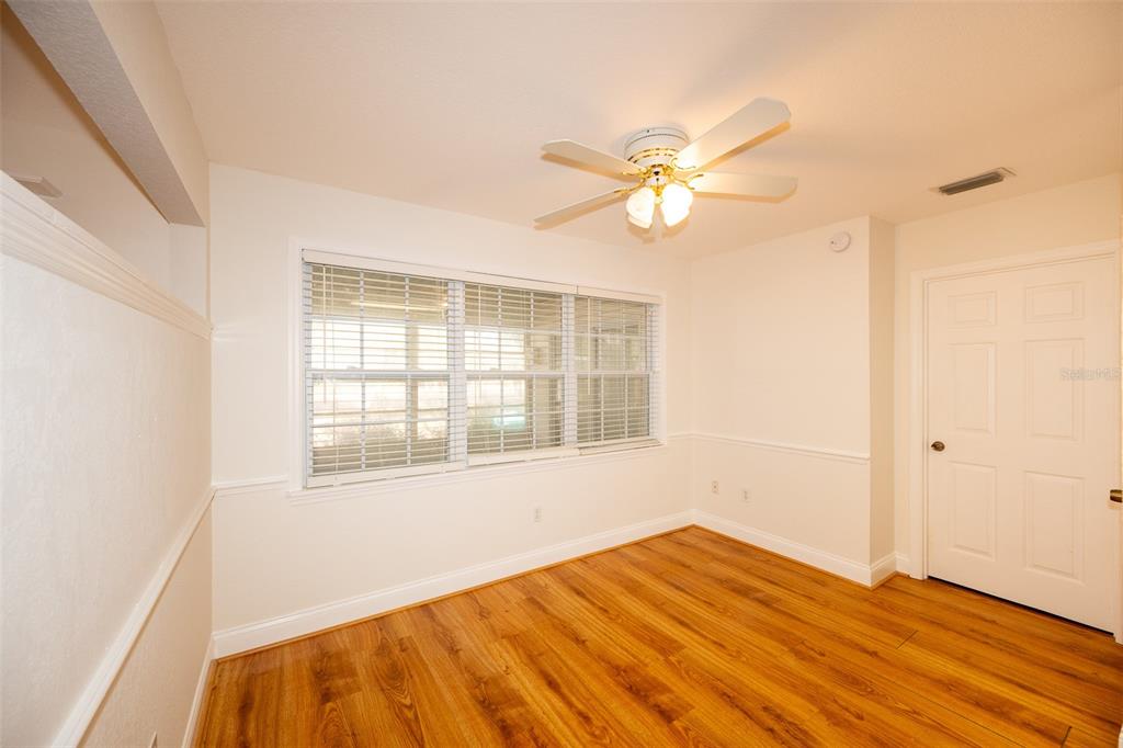 8077 Lake Hatchineha Road Haines City, FL 33844 - Photo 15 of 45 a view of an empty room with wooden floor and a window