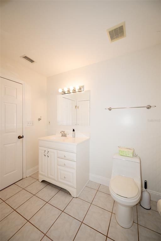 8077 Lake Hatchineha Road Haines City, FL 33844 - Photo 22 of 45 a bathroom with a granite countertop toilet and a sink