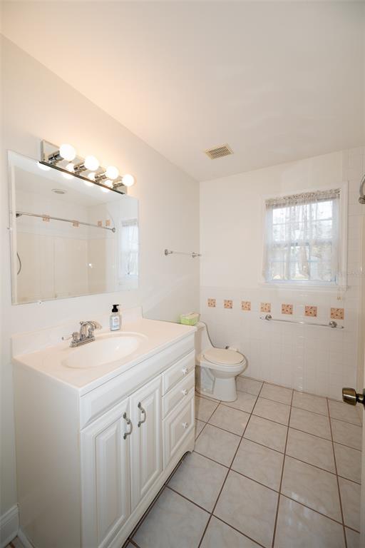 8077 Lake Hatchineha Road Haines City, FL 33844 - Photo 23 of 45 a spacious bathroom with a double vanity sink mirror and toilet