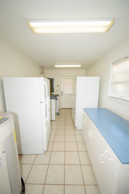 8077 Lake Hatchineha Road Haines City, FL 33844 - Photo 25 of 45 a hallway with a white cabinet door and a hallway