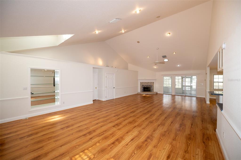 8077 Lake Hatchineha Road Haines City, FL 33844 - Photo 3 of 45 a view of empty room with wooden floor and windows
