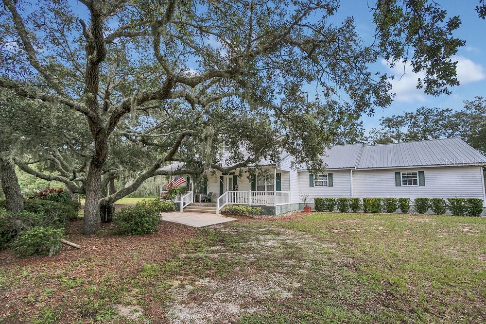 8077 Lake Hatchineha Road Haines City, FL 33844 - Photo 32 of 45 a front view of a house with a yard