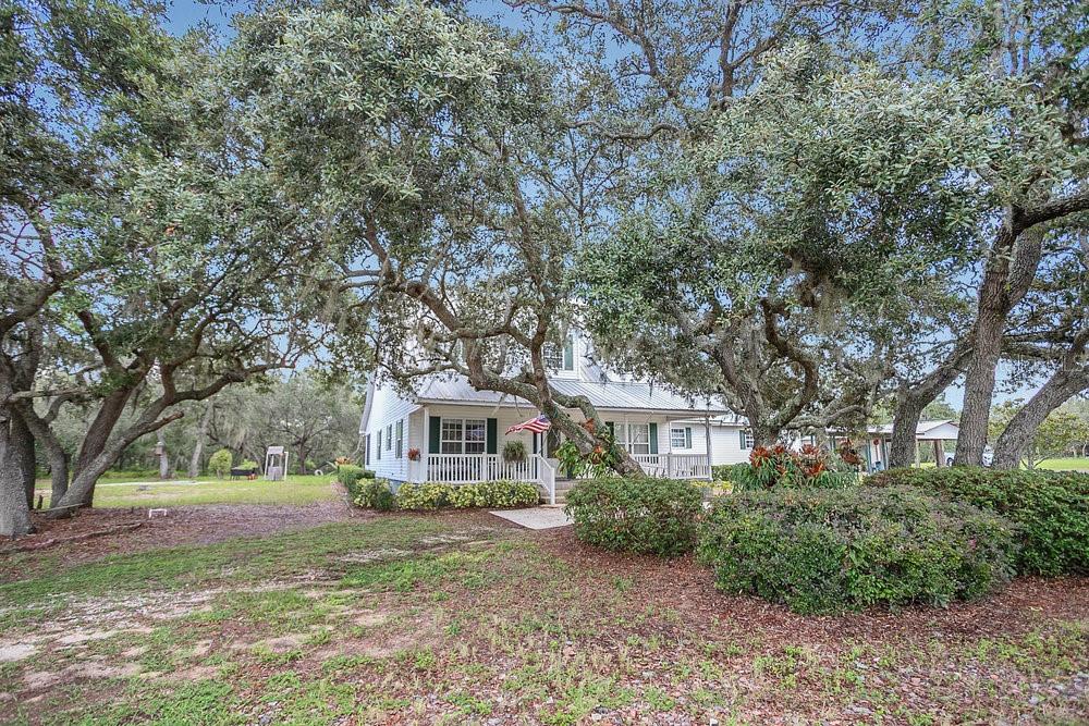 8077 Lake Hatchineha Road Haines City, FL 33844 - Photo 33 of 45 a front view of a house with a yard