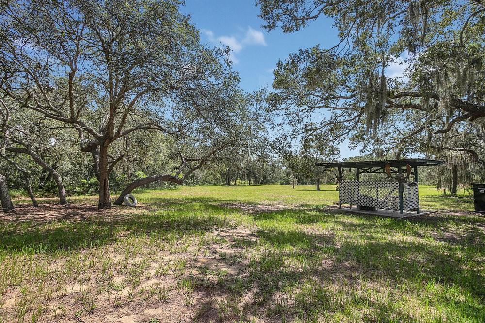 8077 Lake Hatchineha Road Haines City, FL 33844 - Photo 38 of 45 a view of a garden with a bench