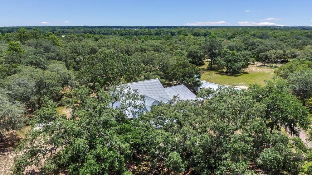 8077 Lake Hatchineha Road Haines City, FL 33844 - Photo 43 of 45 an aerial view of residential houses with outdoor space and trees all around