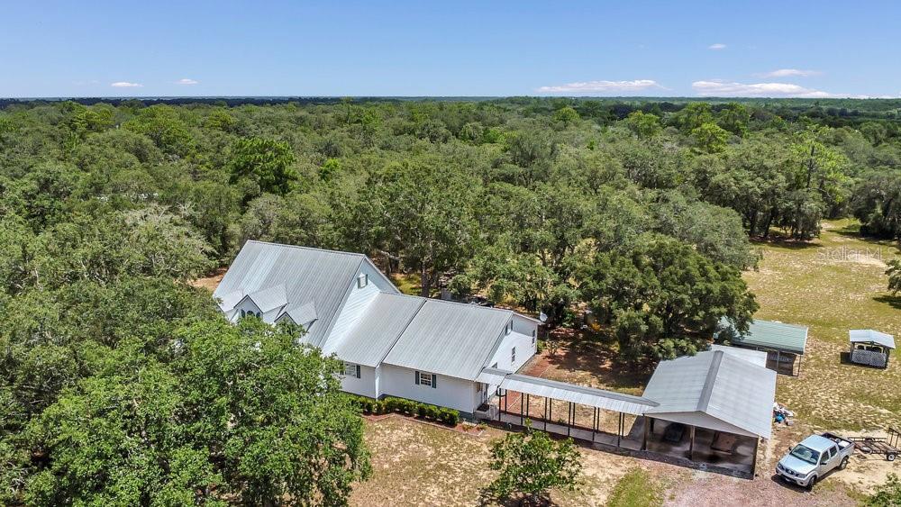 8077 Lake Hatchineha Road Haines City, FL 33844 - Photo 44 of 45 an aerial view of a house with a yard and lake view