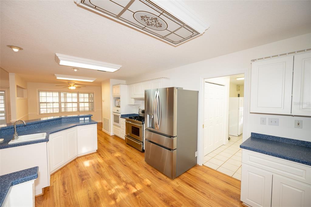 8077 Lake Hatchineha Road Haines City, FL 33844 - Photo 8 of 45 a kitchen with granite countertop a refrigerator and a sink