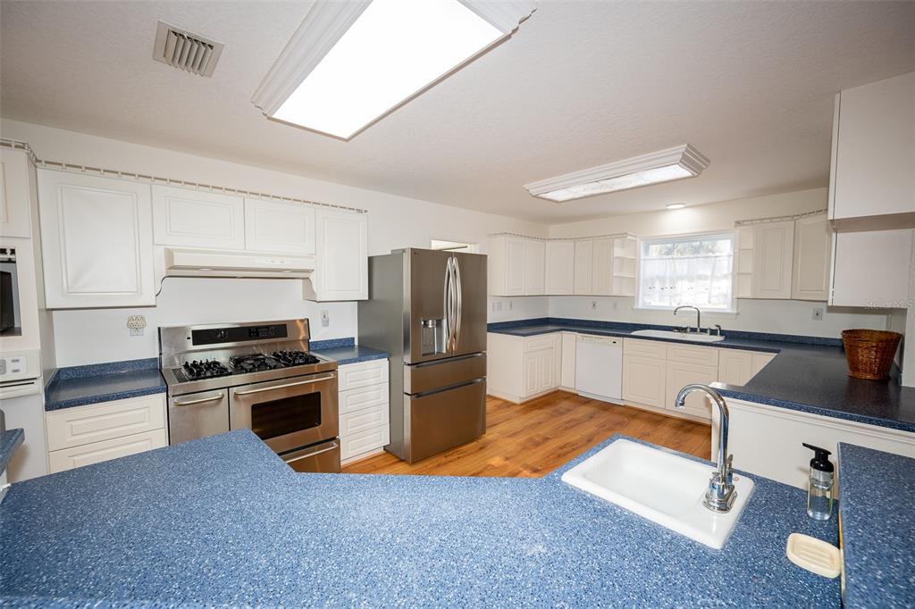 8077 Lake Hatchineha Road Haines City, FL 33844 - Photo 9 of 45 a kitchen with granite countertop a sink stainless steel appliances and cabinets