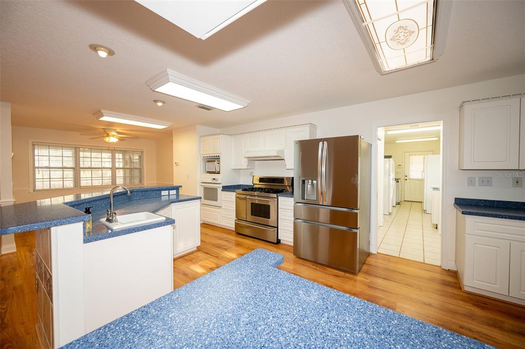 8077 Lake Hatchineha Road Haines City, FL 33844 - Photo 10 of 45 a kitchen with a refrigerator and a stove top oven
