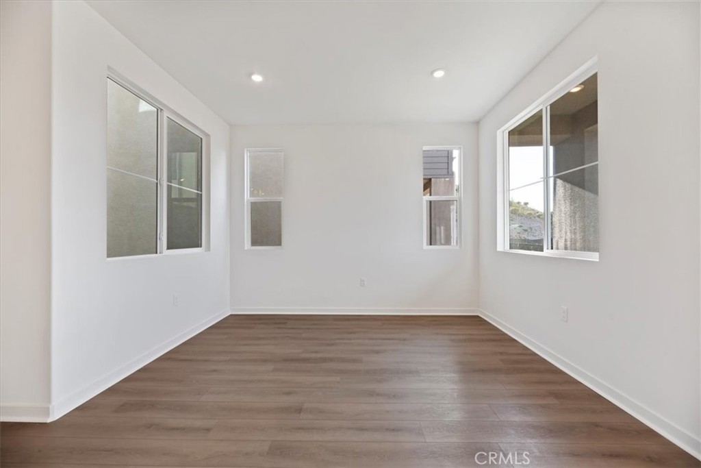 27323 Maverick Place Valencia, CA 91381 - Photo 3 of 18 a view of empty room with wooden floor and fan