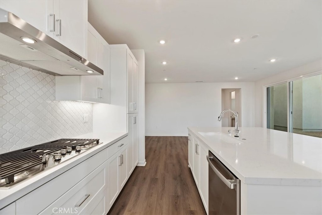 27323 Maverick Place Valencia, CA 91381 - Photo 5 of 18 a kitchen with stove and white cabinets