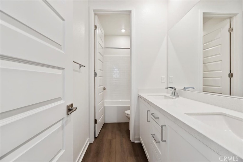 27323 Maverick Place Valencia, CA 91381 - Photo 8 of 18 a bathroom with a double vanity sink and mirror with toilet