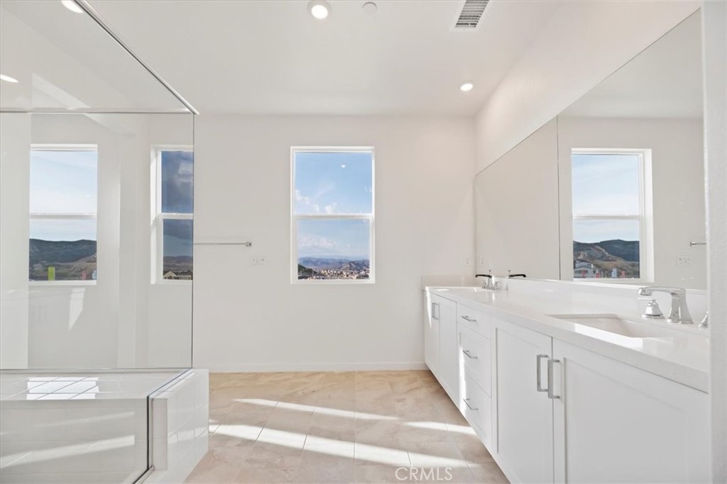 27323 Maverick Place Valencia, CA 91381 - Photo 10 of 18 a spacious bathroom with a tub sink and mirror