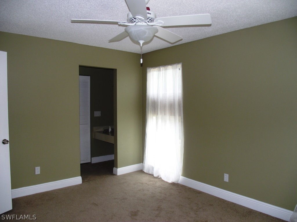 1085 Ridgeway Drive North Fort Myers, FL 33903 - Photo 15 of 25 an empty room with closet and a chandelier fan