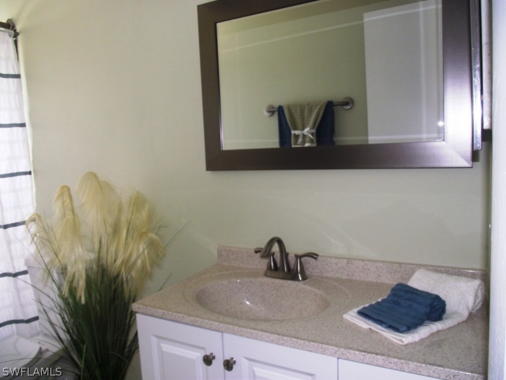 1085 Ridgeway Drive North Fort Myers, FL 33903 - Photo 23 of 25 a bathroom with a sink and a mirror