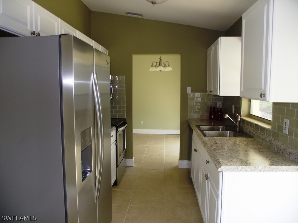 1085 Ridgeway Drive North Fort Myers, FL 33903 - Photo 7 of 25 a kitchen with stainless steel appliances granite countertop a refrigerator and a sink