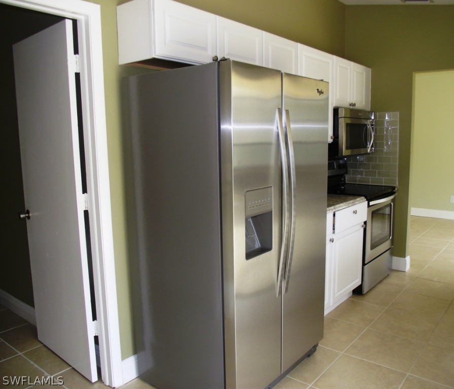 1085 Ridgeway Drive North Fort Myers, FL 33903 - Photo 8 of 25 a metallic refrigerator freezer sitting in a kitchen