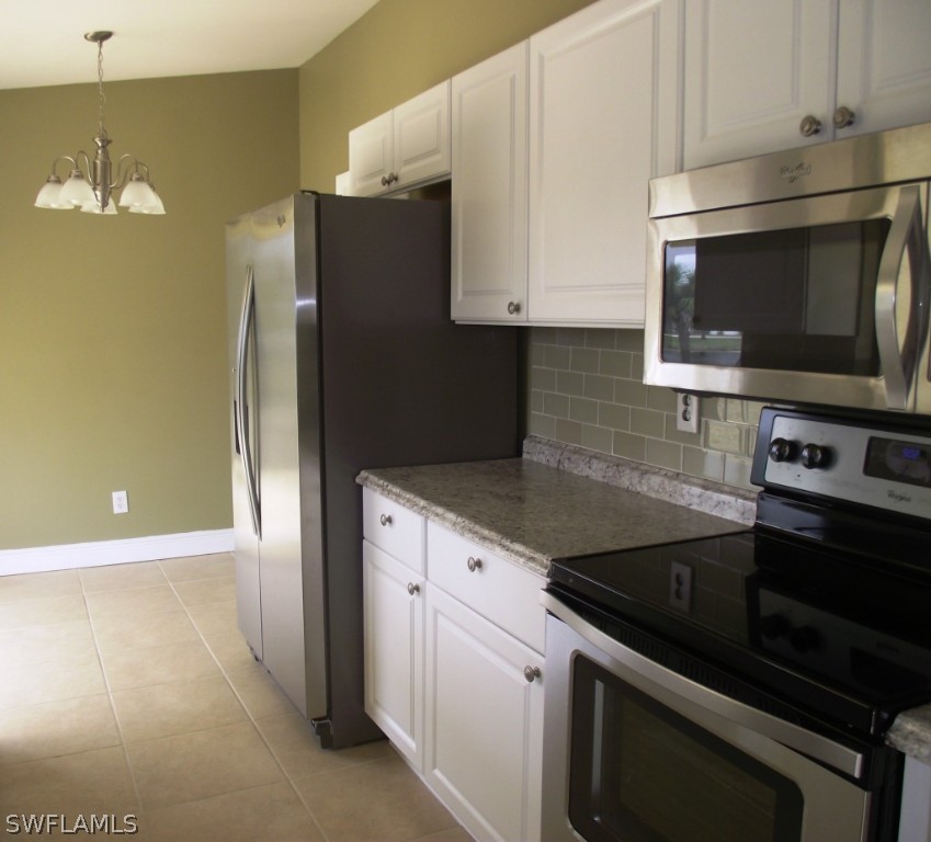 1085 Ridgeway Drive North Fort Myers, FL 33903 - Photo 9 of 25 a kitchen with stainless steel appliances a stove microwave and sink