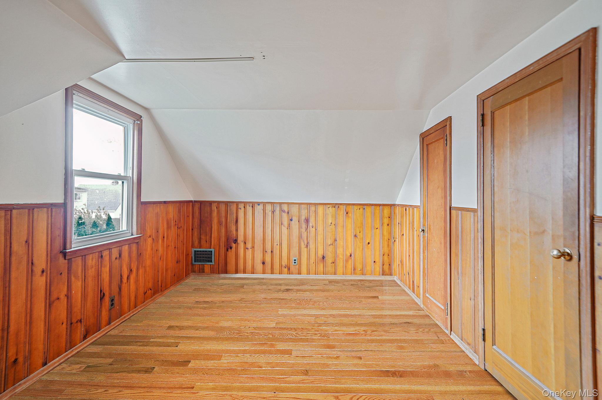 15 Berkshire Road Merrick, NY 11566 - Photo 11 of 11 a view of a room with a window and wooden floor