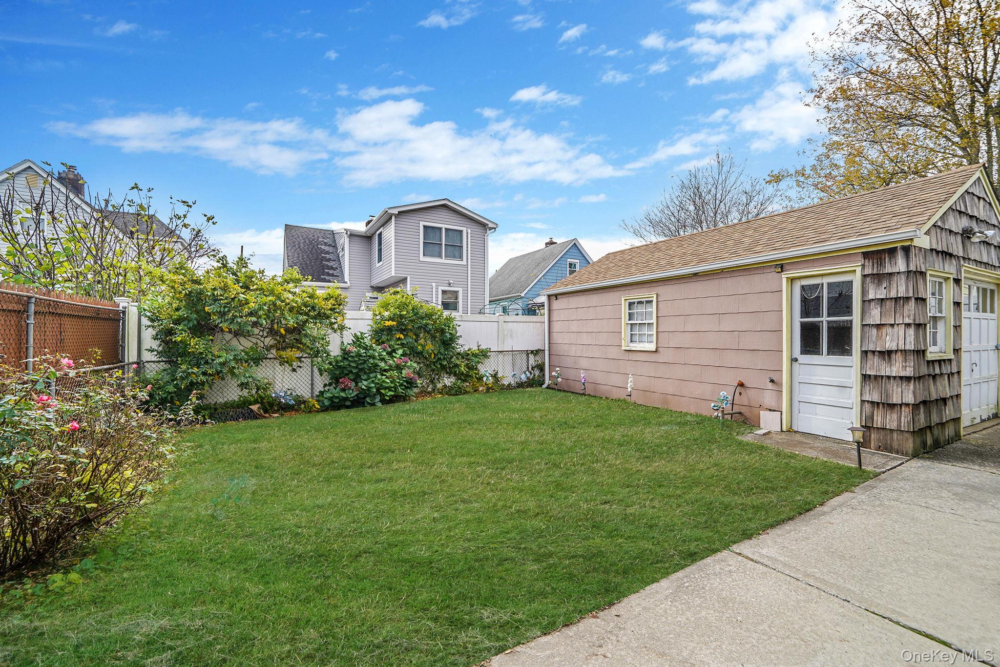 15 Berkshire Road Merrick, NY 11566 - Photo 2 of 11 a front view of a house with garden