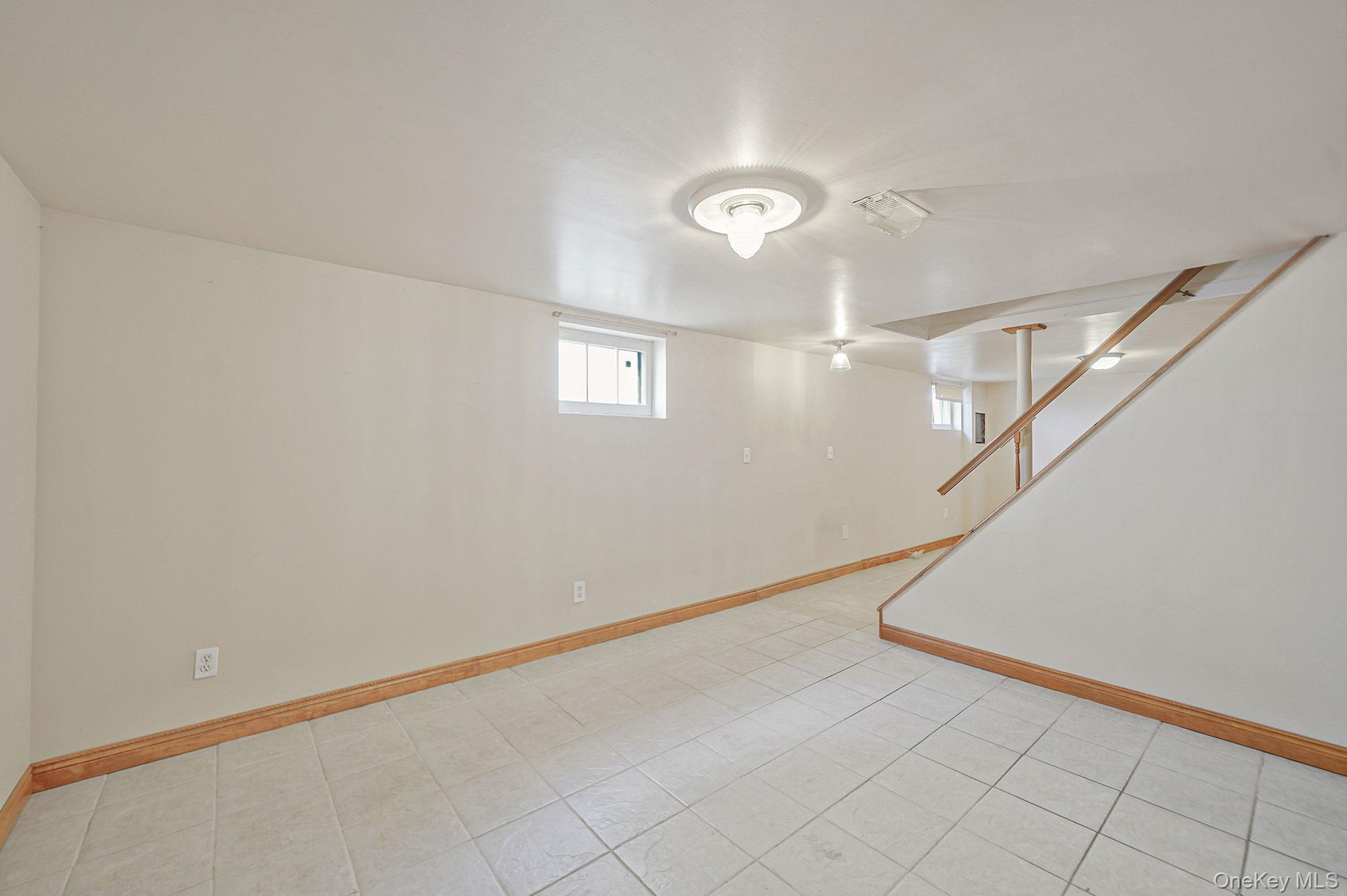 15 Berkshire Road Merrick, NY 11566 - Photo 10 of 11 an empty room with windows and fan