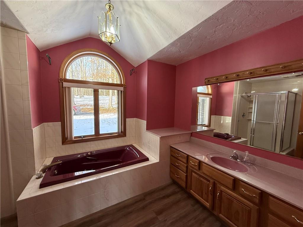 1509 Ray Road Penn Run, PA 15765 - Photo 20 of 33 a bathroom with a granite countertop sink a large mirror and a bathtub