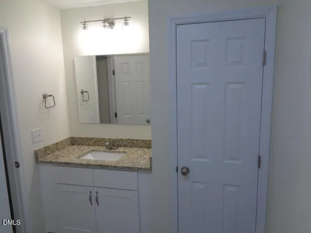 an empty room with a chandelier fan