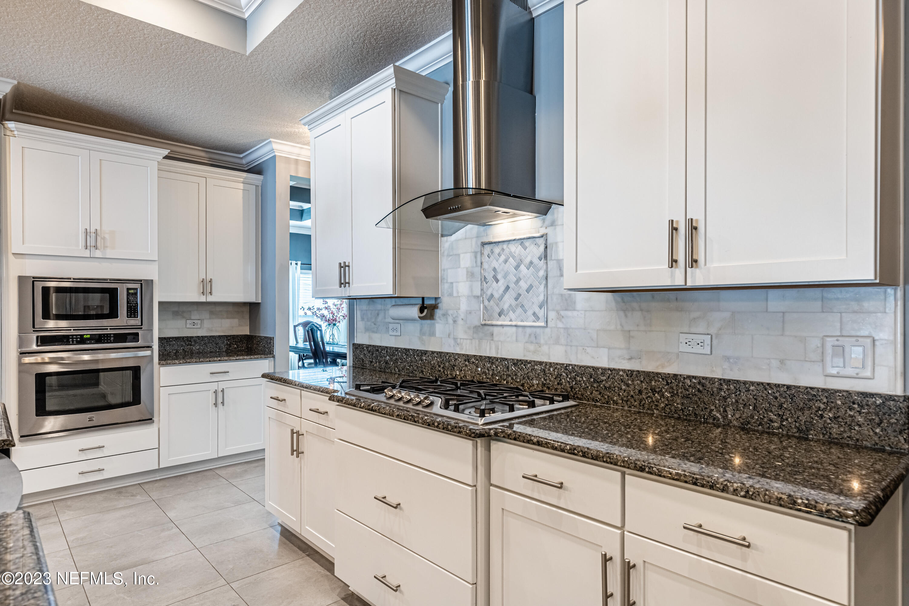 871 Bent Creek Drive St. Johns, FL 32259 - Photo 14 of 71 a kitchen with stainless steel appliances granite countertop white cabinets and a stove a oven with white countertops