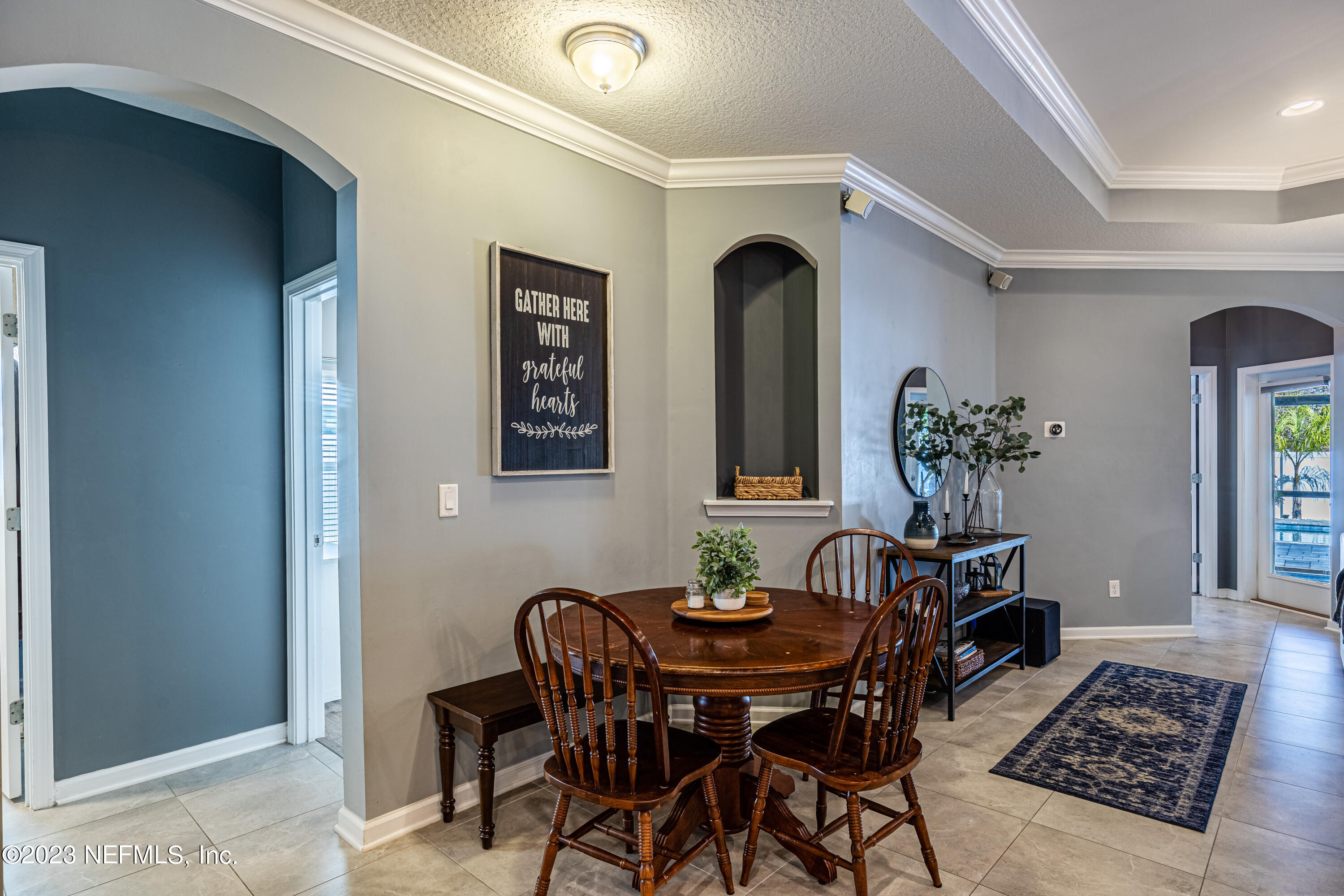 871 Bent Creek Drive St. Johns, FL 32259 - Photo 16 of 71 a view of a dining room with furniture and chandelier