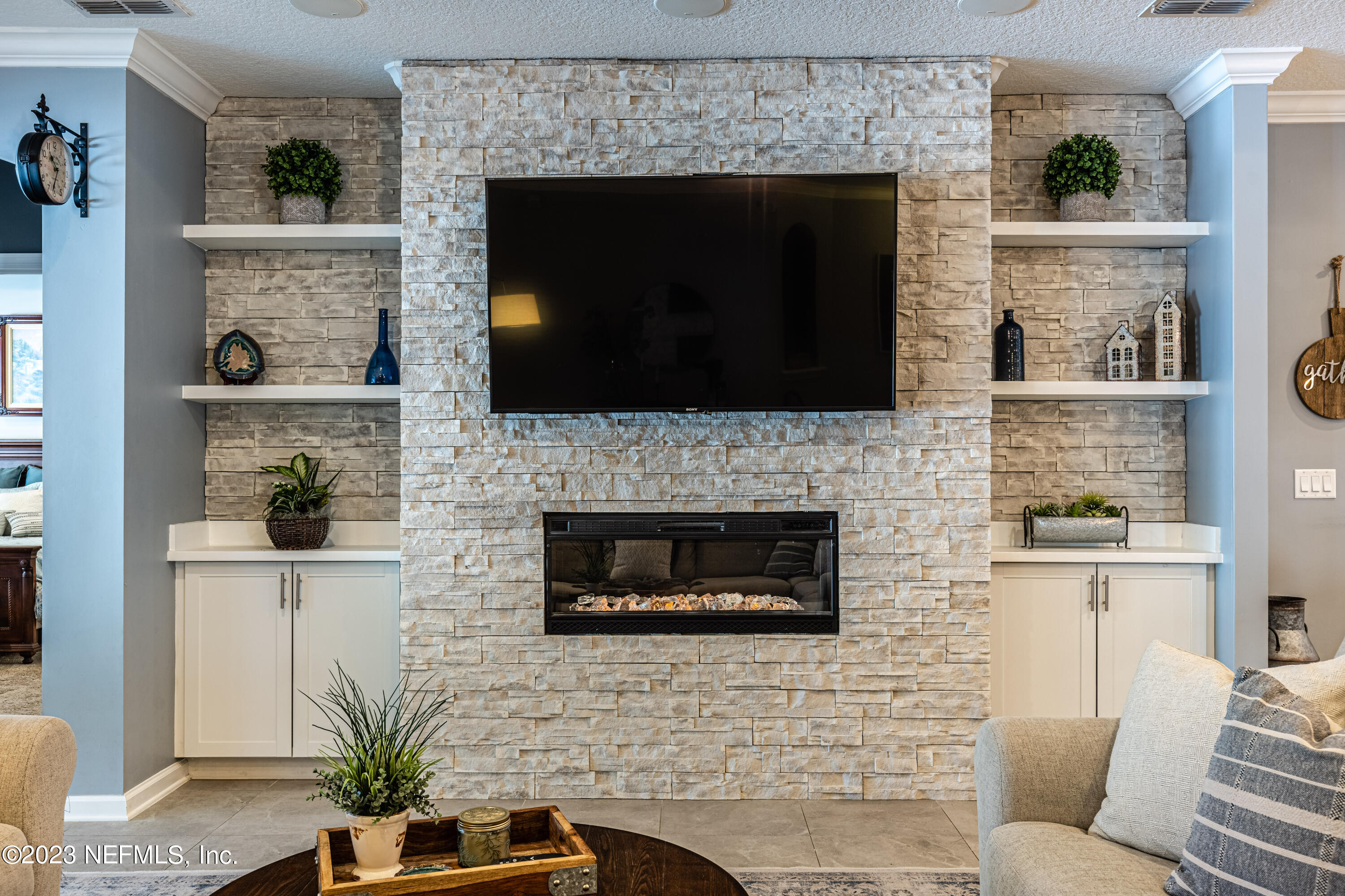 871 Bent Creek Drive St. Johns, FL 32259 - Photo 25 of 71 a living room with a fireplace a flat screen tv and a fireplace