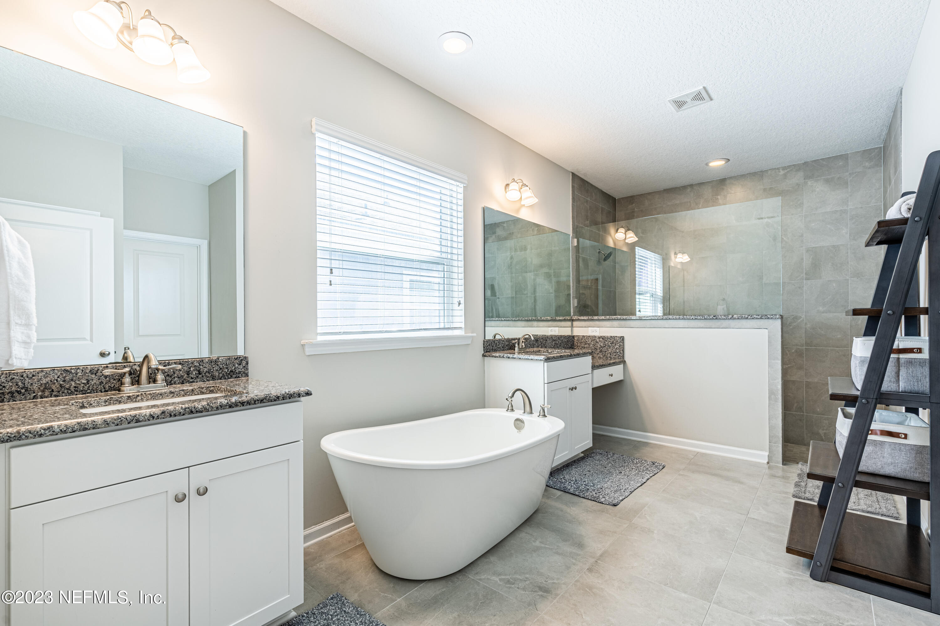 871 Bent Creek Drive St. Johns, FL 32259 - Photo 30 of 71 a bathroom with a double vanity sink a mirror and a bathtub