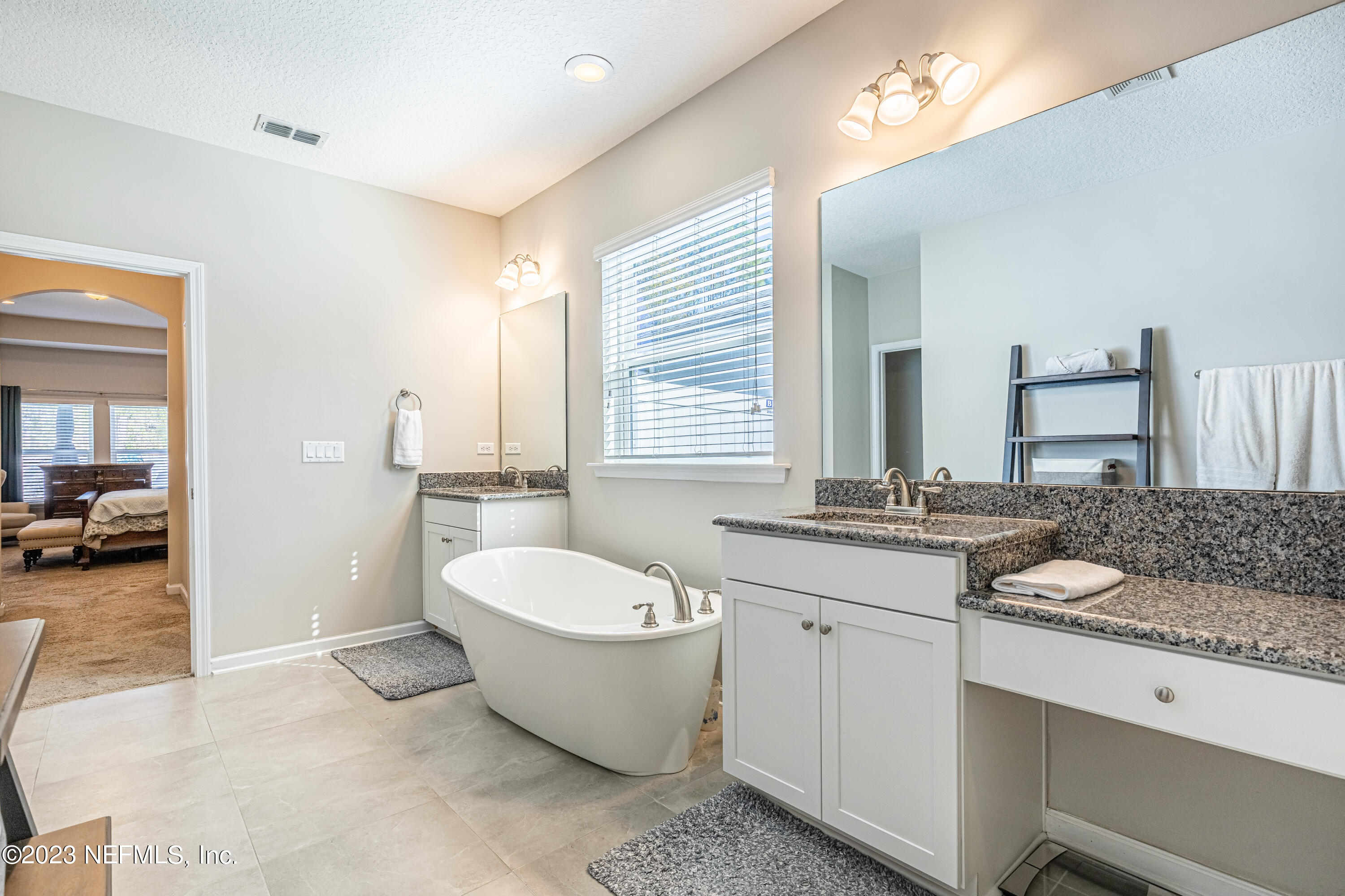 871 Bent Creek Drive St. Johns, FL 32259 - Photo 34 of 71 a spacious bathroom with a double vanity sink a mirror and a bathtub