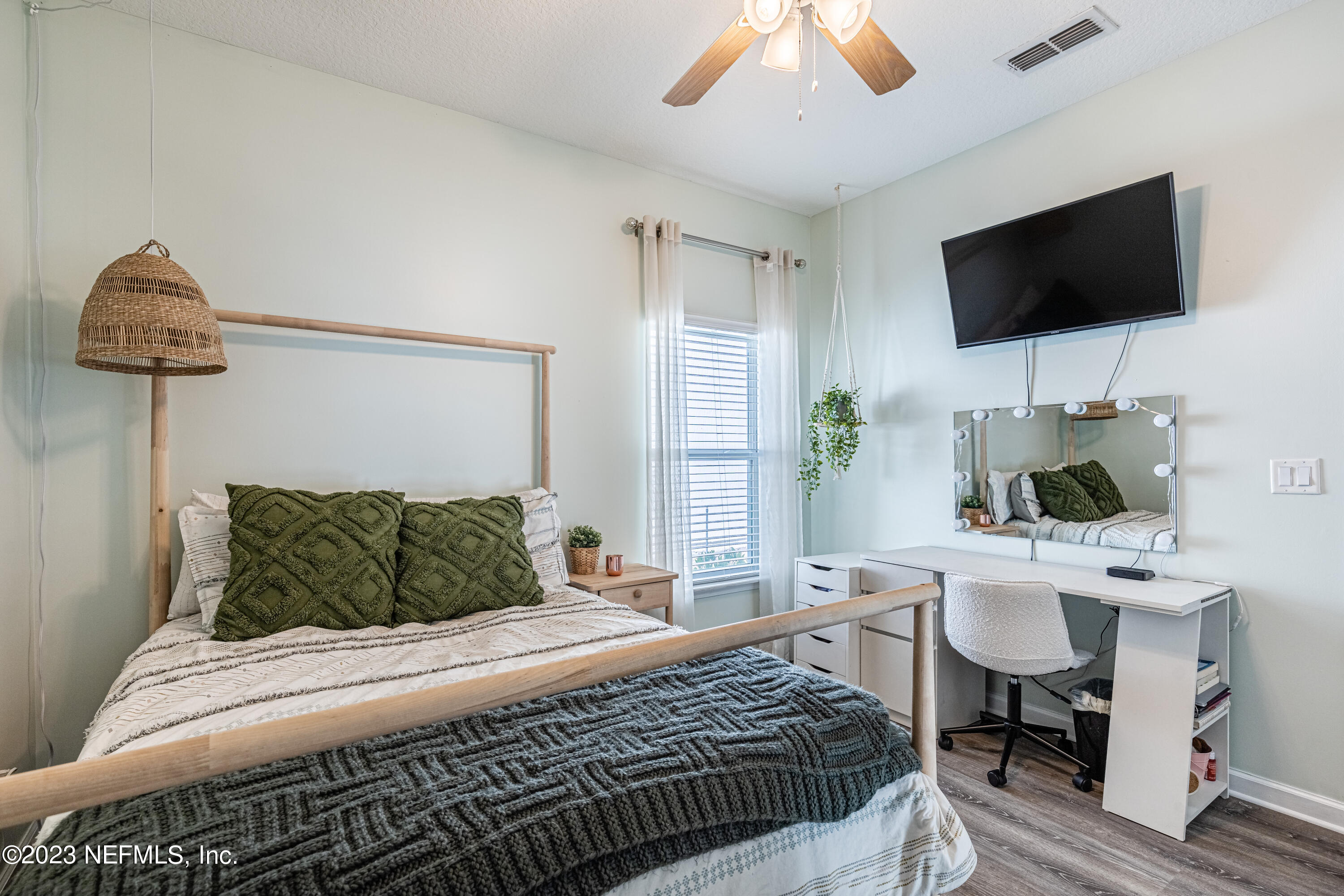 871 Bent Creek Drive St. Johns, FL 32259 - Photo 42 of 71 a bedroom with a bed a window and a flat screen television